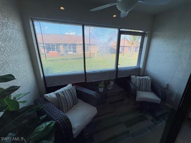 sunroom / solarium featuring a ceiling fan