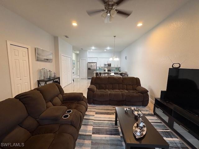 living area featuring recessed lighting, visible vents, and ceiling fan with notable chandelier