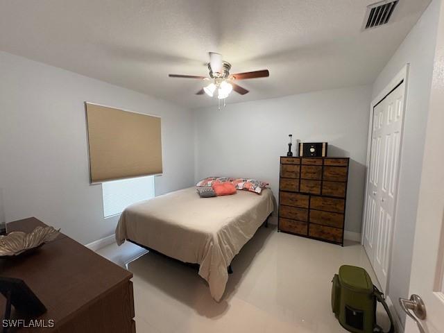 bedroom with a closet, visible vents, ceiling fan, and baseboards