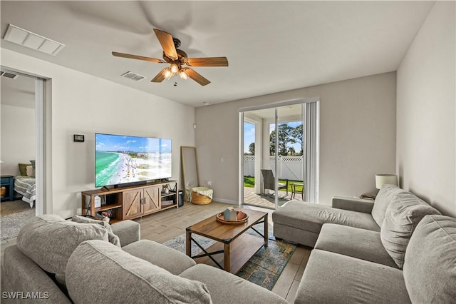 living room featuring ceiling fan and wood-type flooring