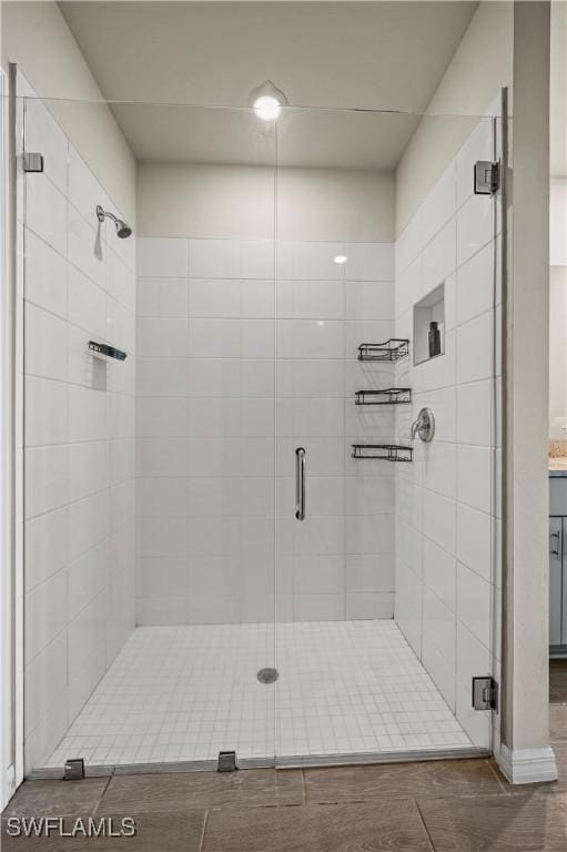 bathroom with a shower with door