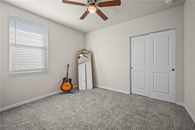 unfurnished bedroom featuring carpet flooring and ceiling fan