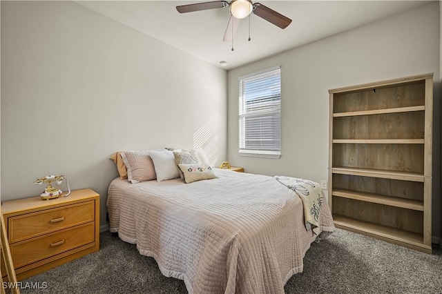 bedroom featuring ceiling fan and dark colored carpet