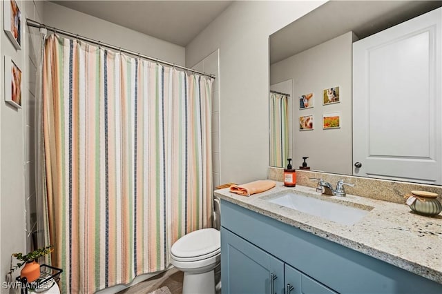 bathroom featuring vanity, toilet, and a shower with shower curtain