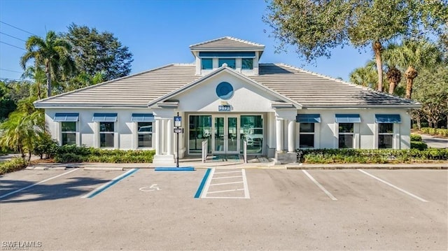 view of building exterior with uncovered parking