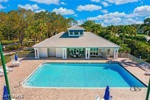 pool with a patio area and an outdoor structure