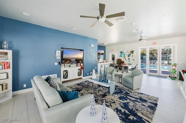 living room with ceiling fan, french doors, visible vents, and baseboards