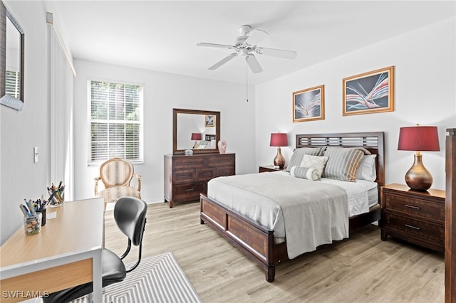 bedroom with a ceiling fan and light wood-style flooring