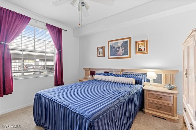 bedroom with a ceiling fan, light carpet, and baseboards