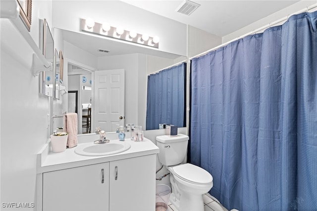 full bathroom featuring toilet, vanity, visible vents, and tile patterned floors