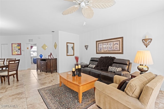 living area with ceiling fan and light tile patterned floors