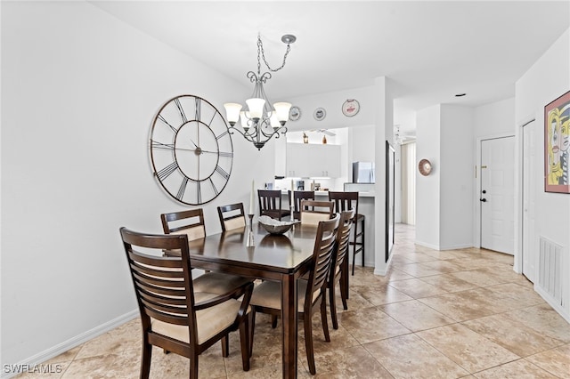 dining area featuring light tile patterned floors, baseboards, visible vents, and an inviting chandelier