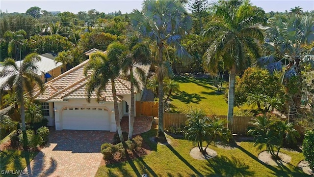 view of front of property featuring a garage and a front lawn