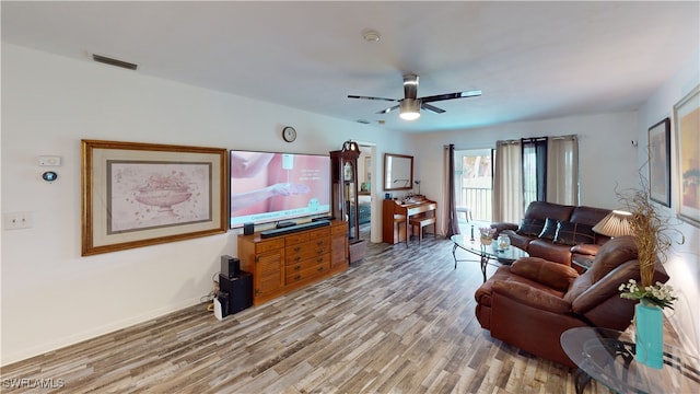 living room featuring ceiling fan and light wood-type flooring