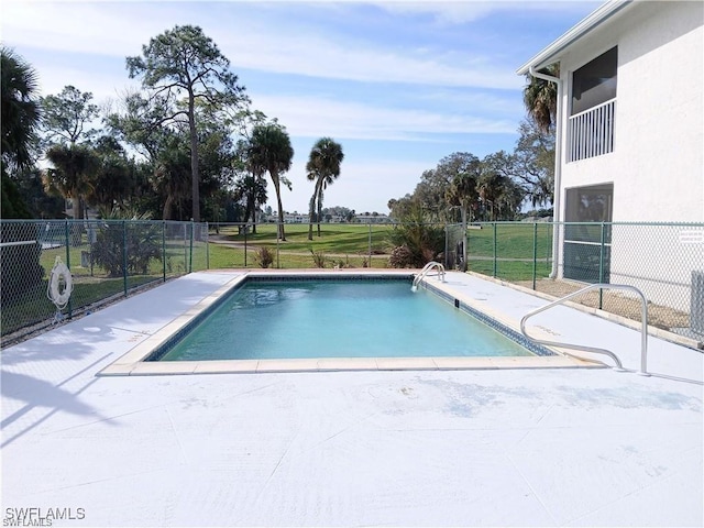 view of swimming pool featuring a yard and a patio