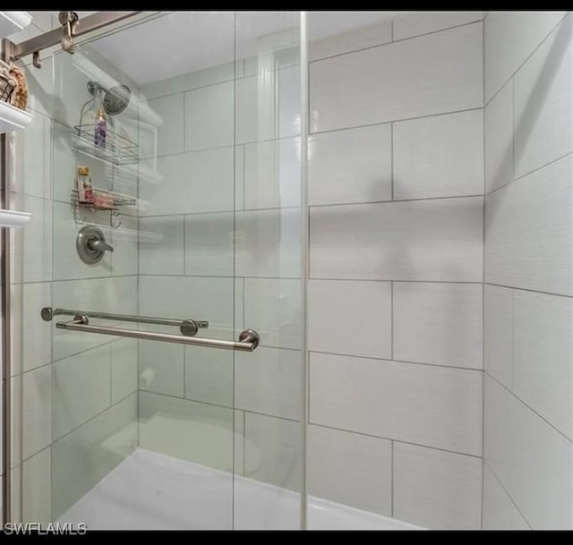 bathroom with a shower with shower door