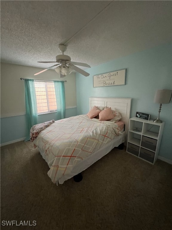 carpeted bedroom featuring ceiling fan and a textured ceiling