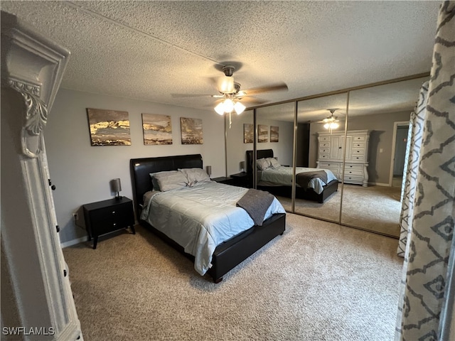 bedroom featuring ceiling fan, a closet, a textured ceiling, and carpet flooring