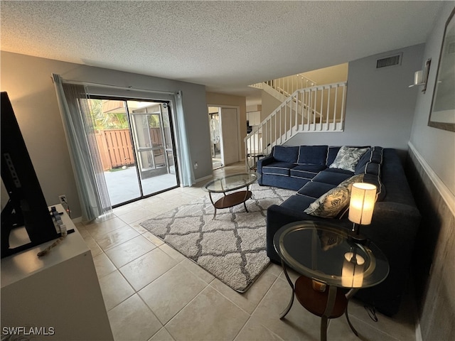 living room with light tile patterned floors and a textured ceiling