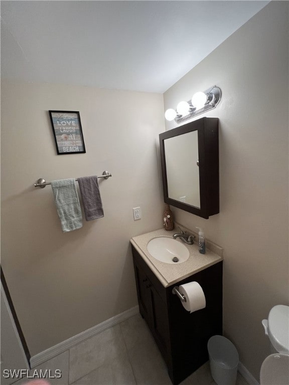 bathroom with vanity, tile patterned floors, and toilet