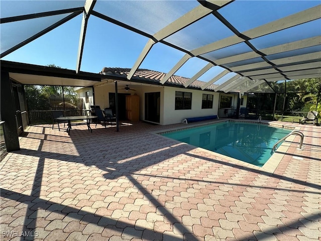 view of pool featuring a patio area, ceiling fan, and glass enclosure