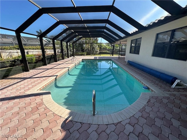 view of pool with a lanai and a patio area