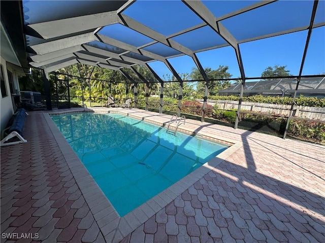 view of pool featuring a patio and glass enclosure