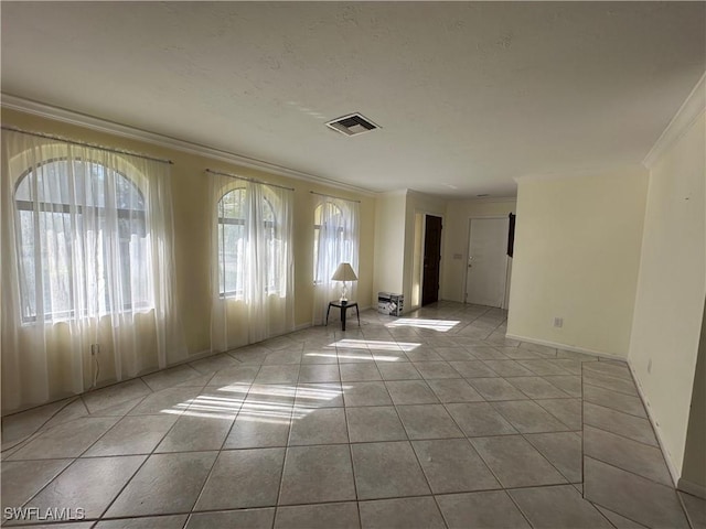 tiled empty room featuring ornamental molding