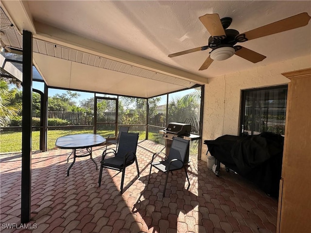 sunroom featuring ceiling fan