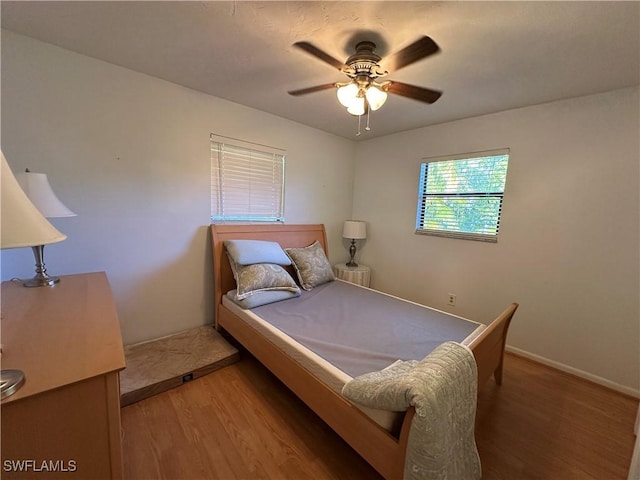 bedroom with hardwood / wood-style floors and ceiling fan