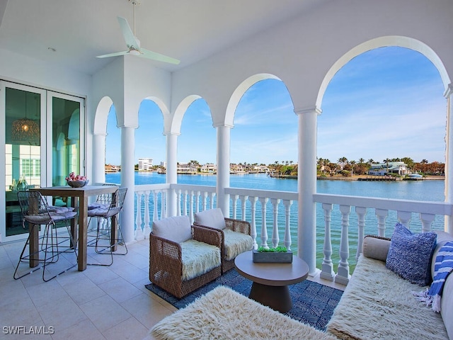 view of patio / terrace with a water view and ceiling fan