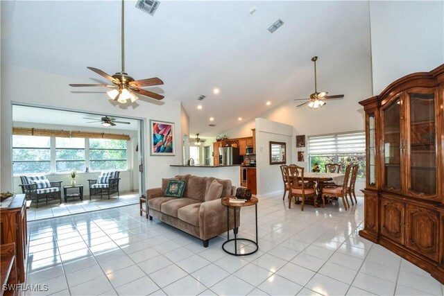 tiled living room featuring high vaulted ceiling