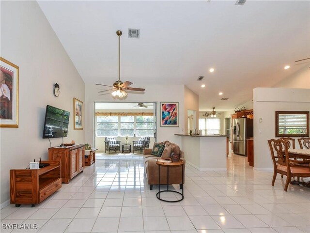 living room featuring lofted ceiling and light tile patterned flooring