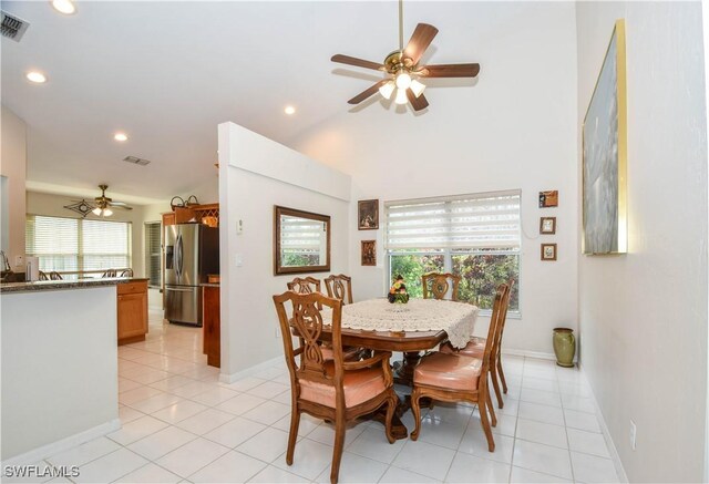 tiled dining room featuring lofted ceiling and ceiling fan