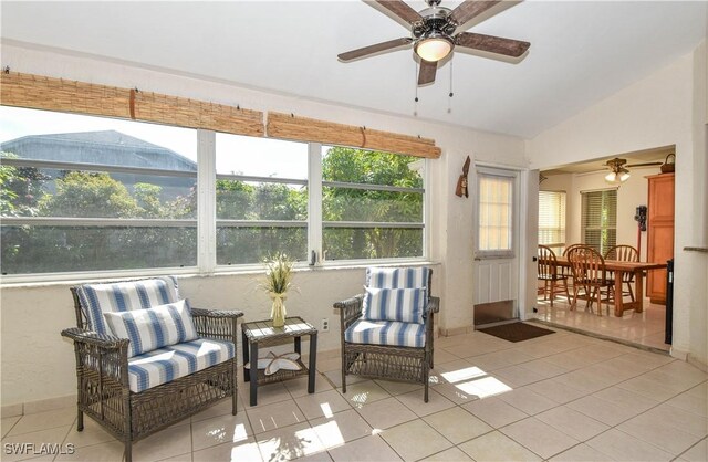 sunroom / solarium featuring lofted ceiling and ceiling fan