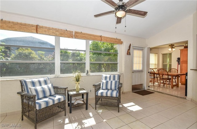 sunroom / solarium with ceiling fan and vaulted ceiling