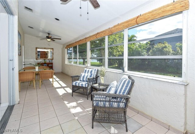 sunroom featuring ceiling fan and vaulted ceiling