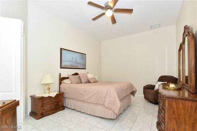 tiled bedroom featuring ceiling fan