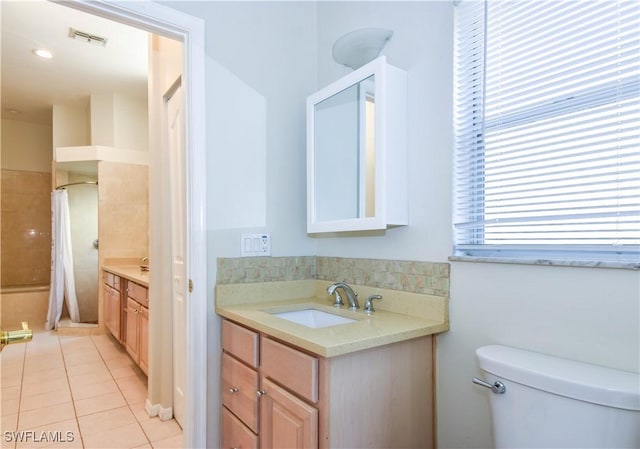 bathroom with toilet, tile patterned flooring, vanity, and walk in shower