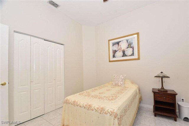 bedroom with a closet and light tile patterned flooring