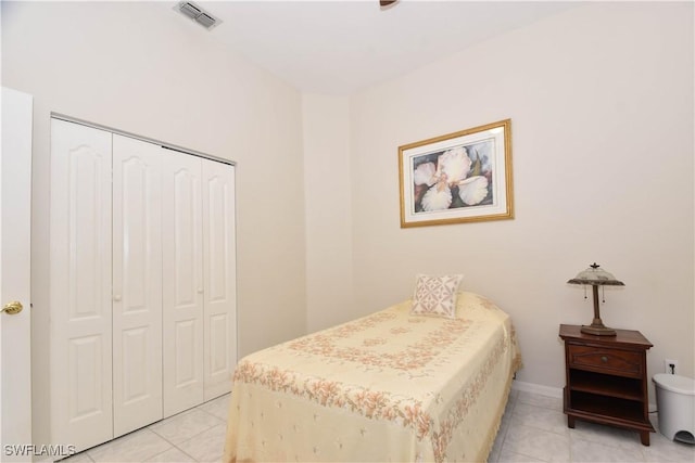 bedroom featuring light tile patterned floors and a closet