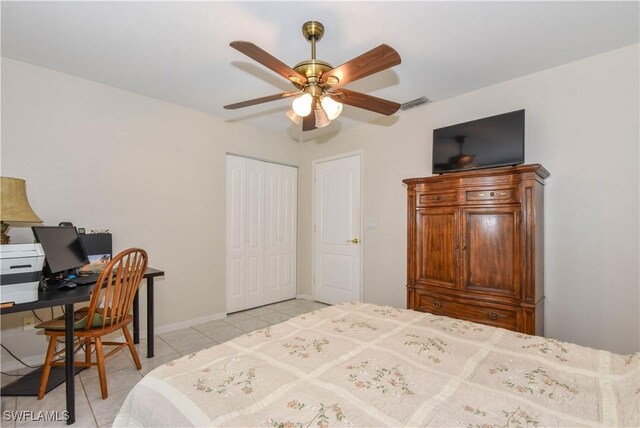 bedroom with light tile patterned floors, a closet, and ceiling fan