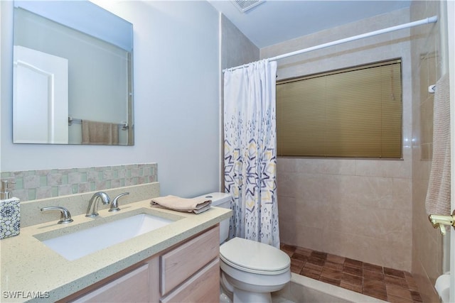 bathroom with toilet, curtained shower, and vanity