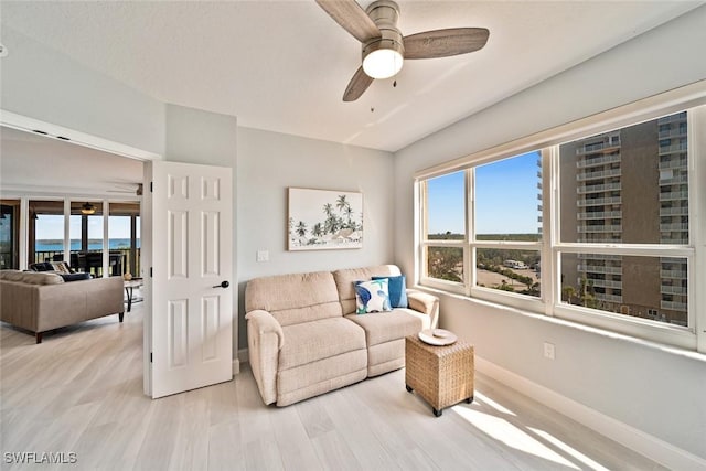 living room featuring ceiling fan and light wood-type flooring