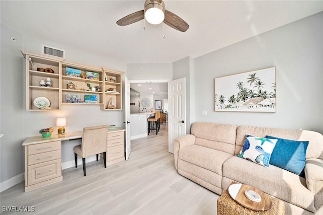 office space with ceiling fan and light wood-type flooring