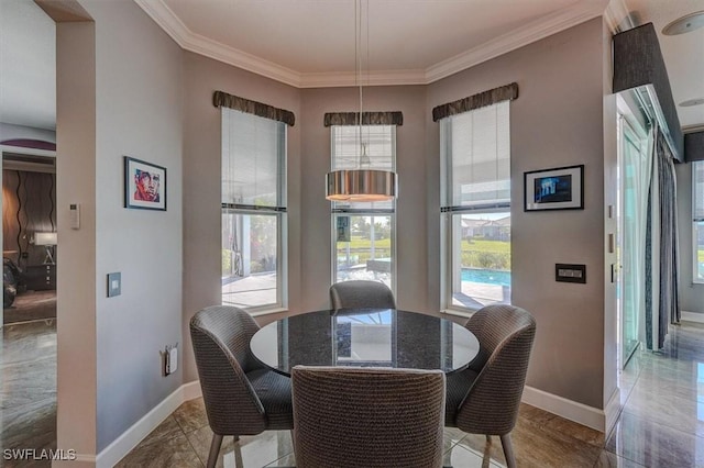 dining area with crown molding and baseboards