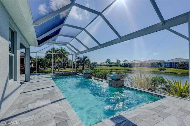 pool featuring glass enclosure, a patio, and a water view