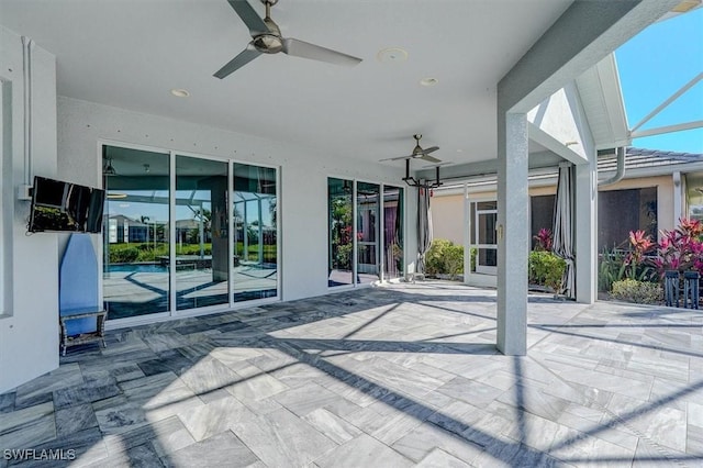 view of patio / terrace with glass enclosure and a ceiling fan