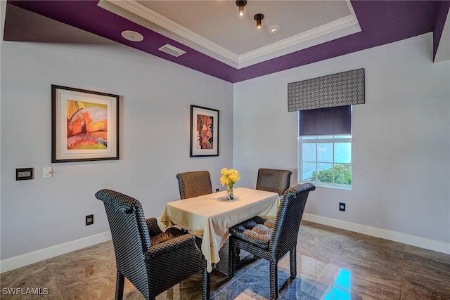 dining space with visible vents, a raised ceiling, baseboards, and ornamental molding