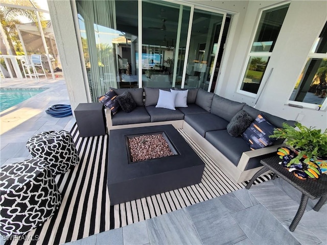 view of patio / terrace with an outdoor pool and an outdoor living space with a fire pit